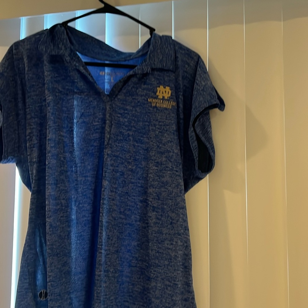 A woman’s polo type notre dame shirt